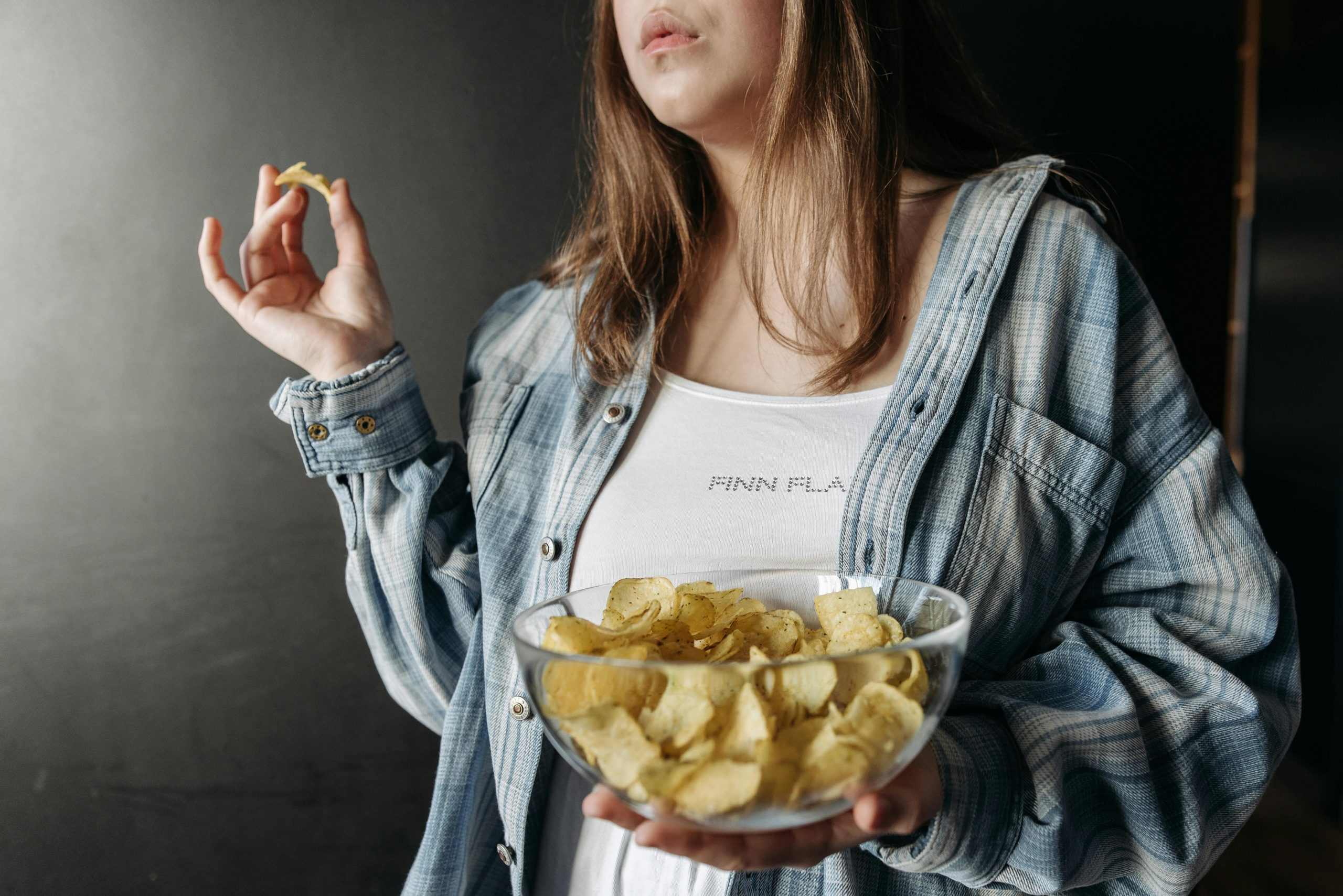 woman holding a bowl of potato chips