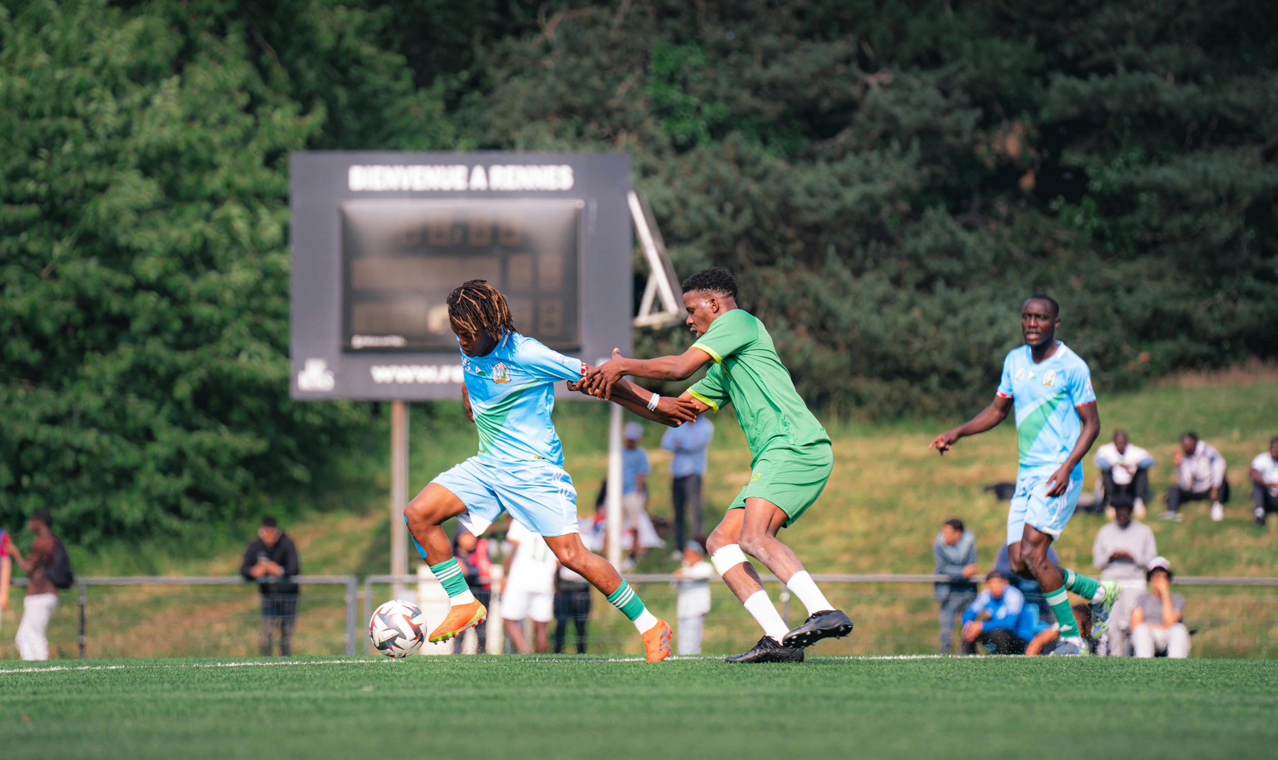 male athletes playing soccer in an open field