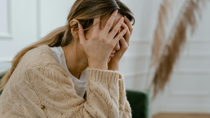 pexels-mart-production-7699511 stressed woman with both hands on her head