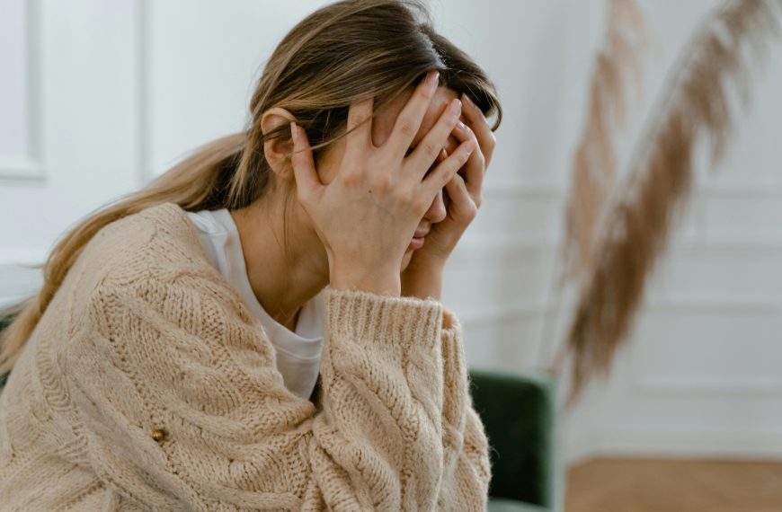 stressed woman with both hands on her head