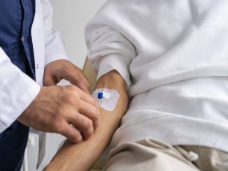 man with an IV in his forearm