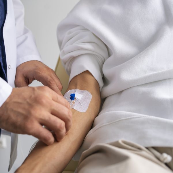 man with an IV in his forearm