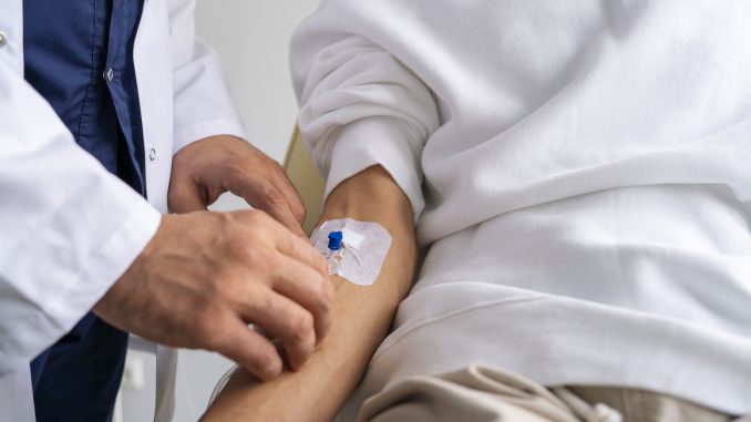 man with an IV in his forearm